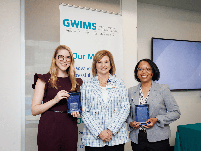 Dr. LouAnn Woodward, vice chancellor for health affairs and dean of the School of Medicine at UMMC, is flanked by two of the GWIMS honorees: Dr. Lais Berro, left, and Dr. Kimberly Bibb.