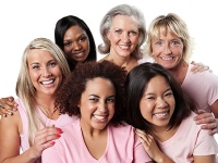 Group of women wearing pink while smiling.