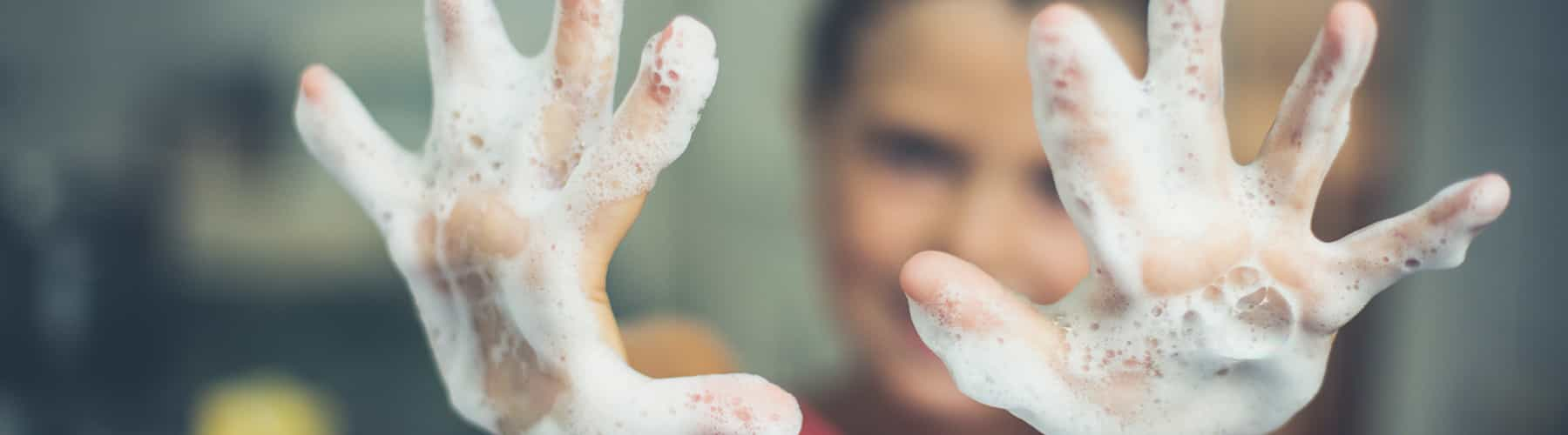 Child holding out soapy hands