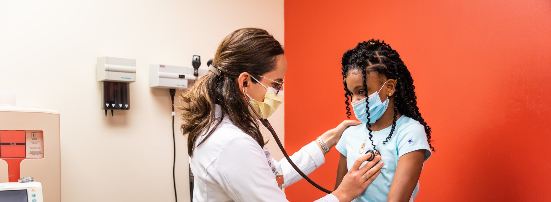 Physician examines patient at Eli Manning Clinic.