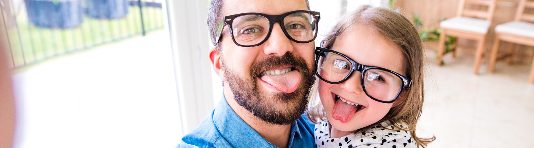 father and child wearing glasses