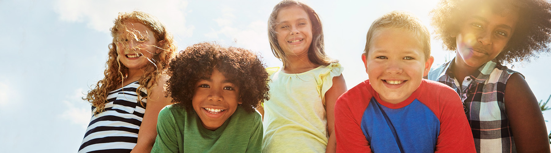 Group of kids looking down into camera.