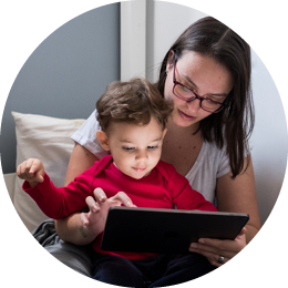 Mother and child looking at computer screen.