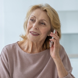 Woman smiles while talking on the phone.
