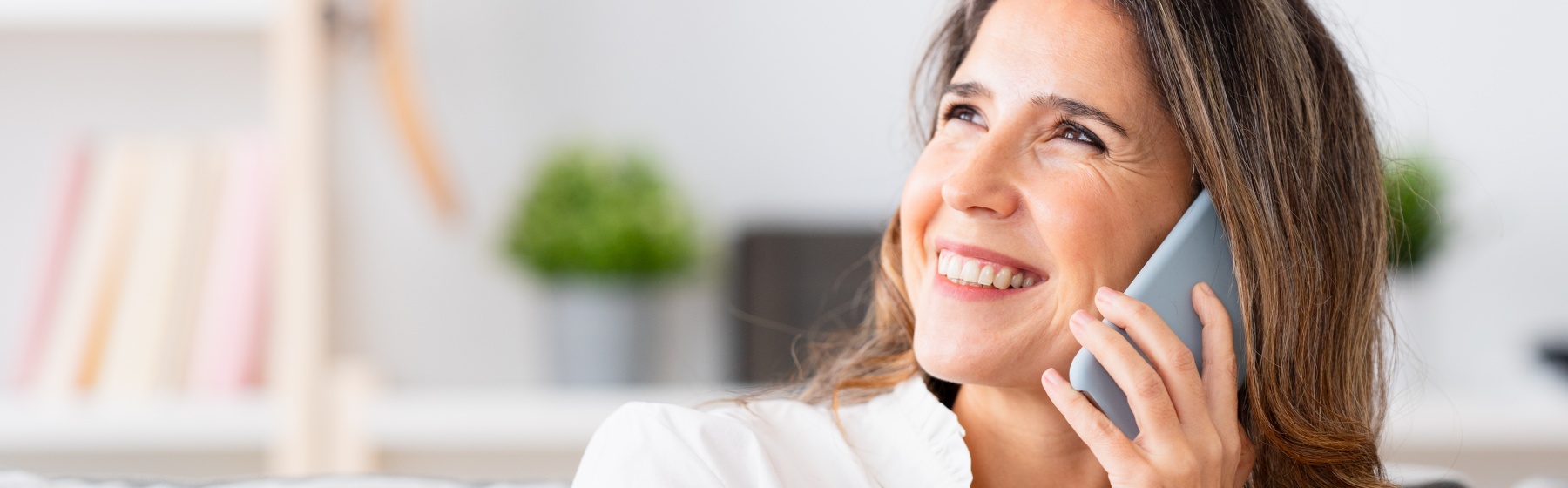 Woman smiles while talking on the phone.