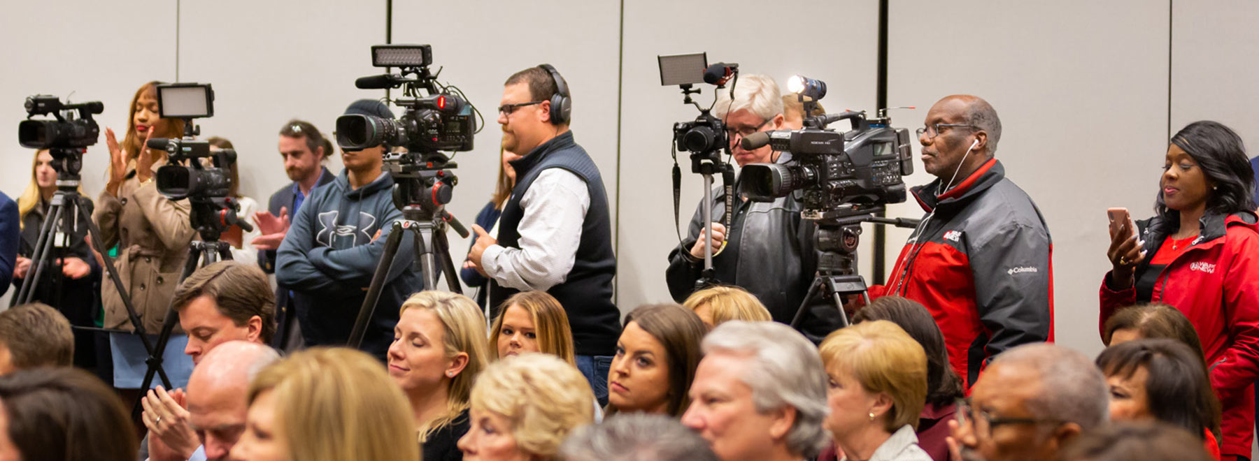Video cameras in the back of the room during an event.