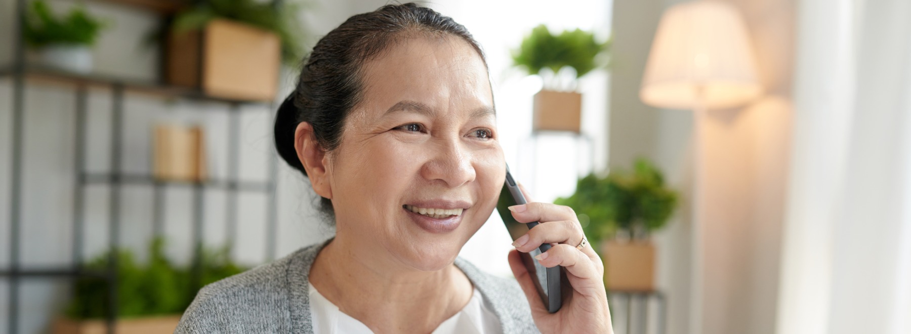 Woman smiles while talking on the phone.