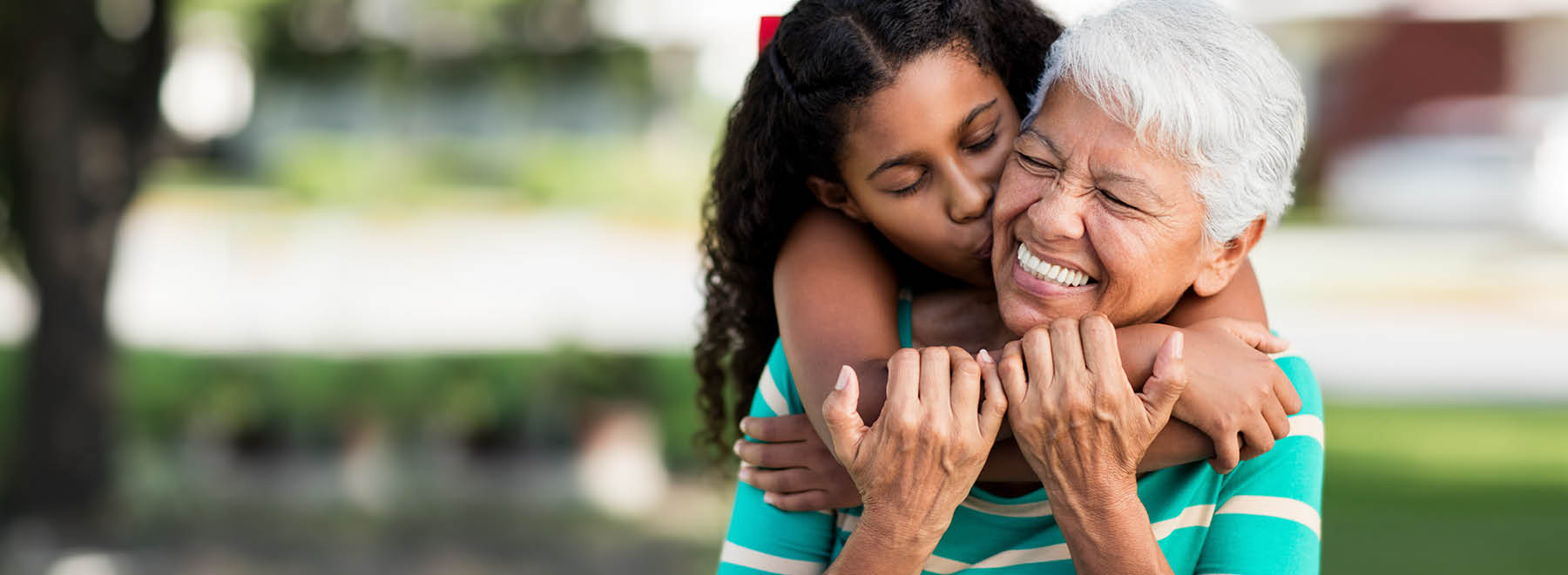 Grandmother and granddaughter embrace