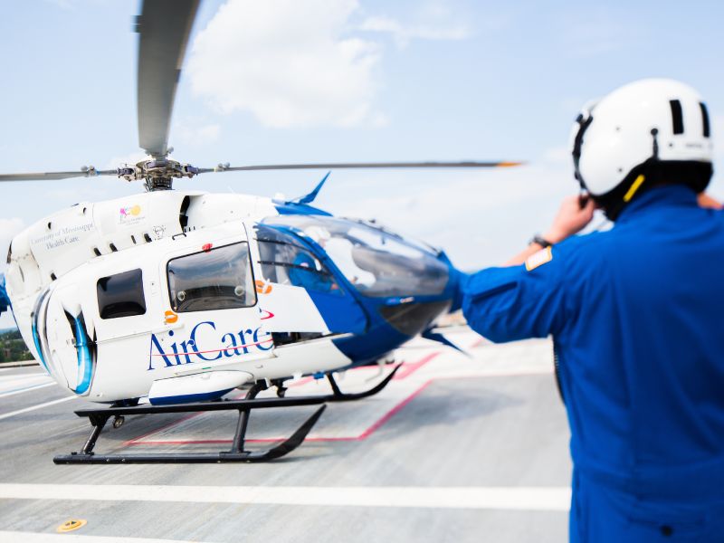 AirCare team member boarding helicopter.