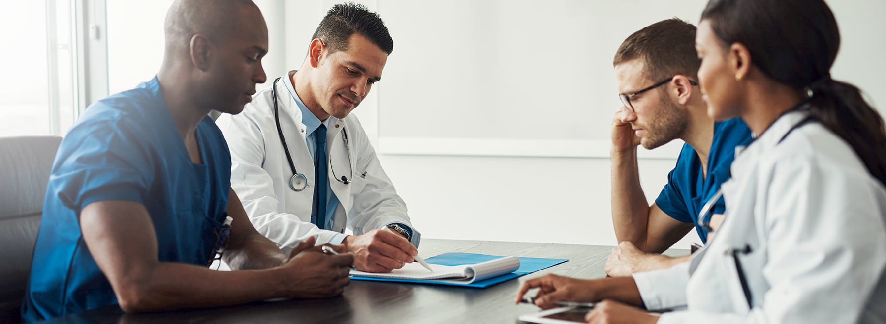 Group of doctors reviewing paperwork