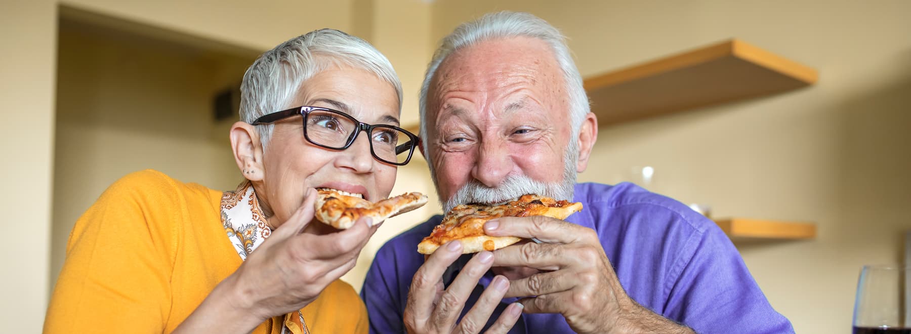 A couple enjoys slices of pizza A couple enjoys slices of pizza