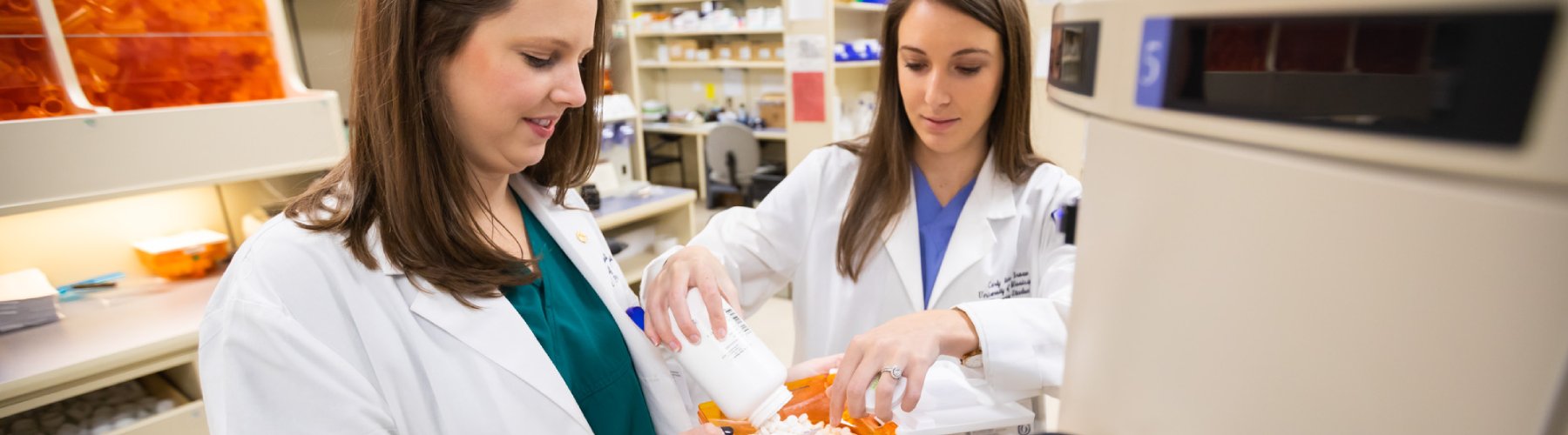 Pharmacists work together to distribute medication.