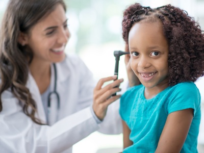 Provider examines pediatric patient.