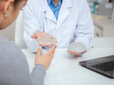 Patient examines implant options with provider.