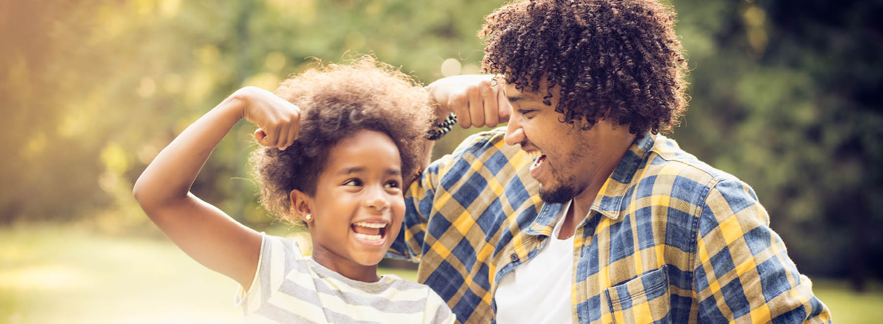 Man and child smiling and flexing their biceps Man and child smiling and flexing their biceps