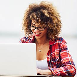 woman seated at desk using laptop