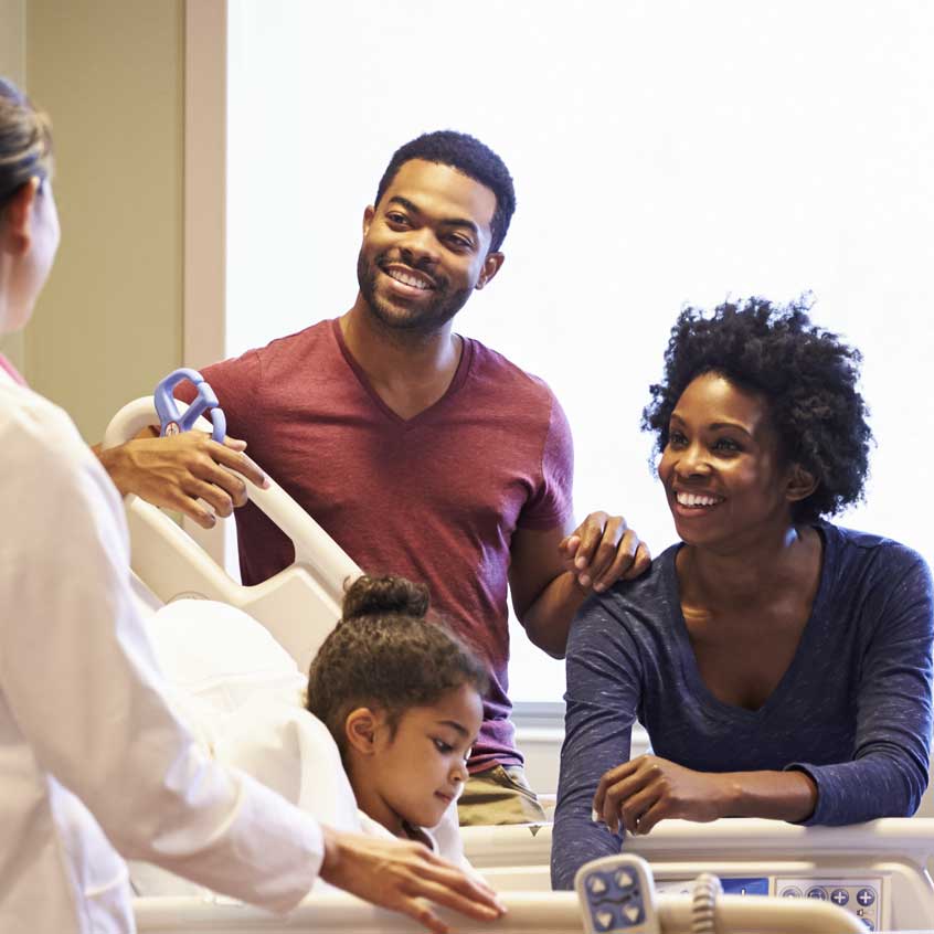 family gathered around a hospital bed