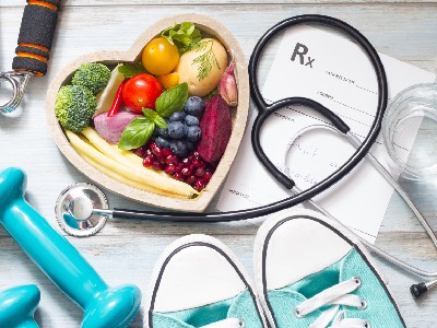 A collage images of fruits in the shape of a heart with exercise equipment around it.