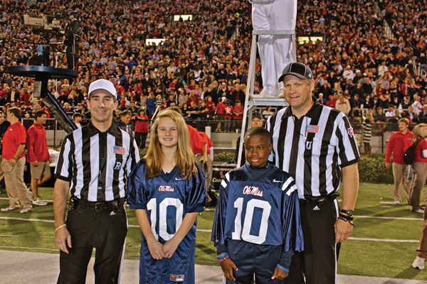 Jacob stands at midfield during a 2013 Ole Miss football game as a "kid co-captain."