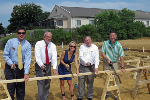 Cutting the first board for framing the 2014 MiracleHome are, from left, Mark Petro, Ridgeland Chamber of Commerce president, Gene McGee, Ridgeland mayor, Leigh Reeves, Friends president, George Gunn, Trustmark executive vice president and Scott Shoemaker, builder.