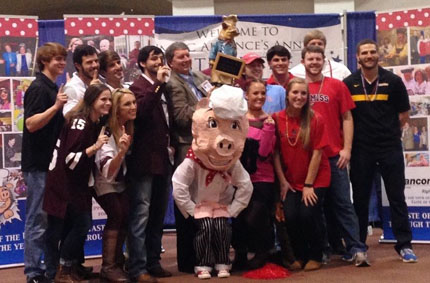 D.P.T. students celebrate their victory with Dr. Fine Swine, Taste of the U mascot.