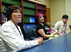 From left, Dr. Mary Taylor, chief of pediatric critical care, Chasity, little Helena and Ray White discuss Helena's remarkable recovery with the media.