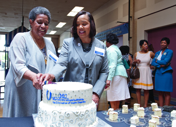 Dr. Myrlie Evers-Williams, left, cuts a cake to celebrate the dedication of the institute named in her honor during a ceremony at the Jackson Medical Mall in Jackson on June 13: the UMMC Myrlie Evers-Williams Institute for the Elimination of Health Disparities. Assisting her is Dr. Bettina Beech, executive director of the institute and associate vice chancellor for population health.