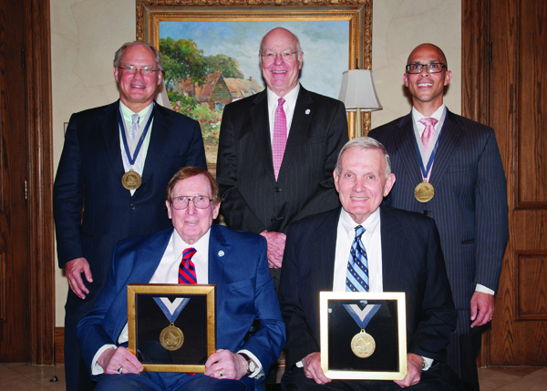 Dr. William Geissler, standing, left, and Dr. George Russell, standing, right, were named recipients of, respectively, the Alan E. Freeland Chair of Orthopedic Hand Surgery and the James L. Hughes Chair of Orthopedic Surgery. The chairs are named in honor of Dr. Alan Freeland, seated, left, and Dr. James Hughes, seated right; each is a professor emeritus at UMMC. Dr. James Keeton, standing, center, vice chancellor for health affairs and dean of the School of Medicine, gave the welcoming remarks at a reception held June 11 at the Country Club of Jackson. Geissler is a professor in the Department of Orthopedic Surgery and Rehabilitation. Russell is professor and chair of the Department of Orthopedic Surgery and Rehabilitation.