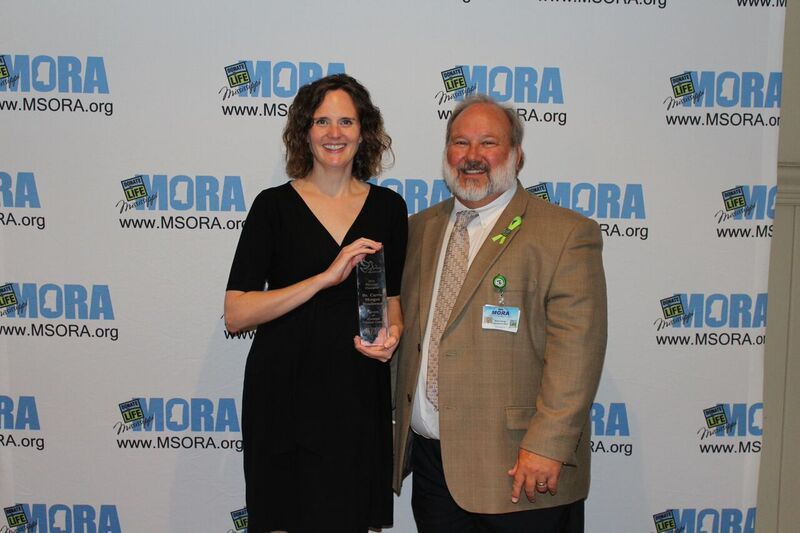 Henderson receives her Spero from Kevin Stump, MORA CEO