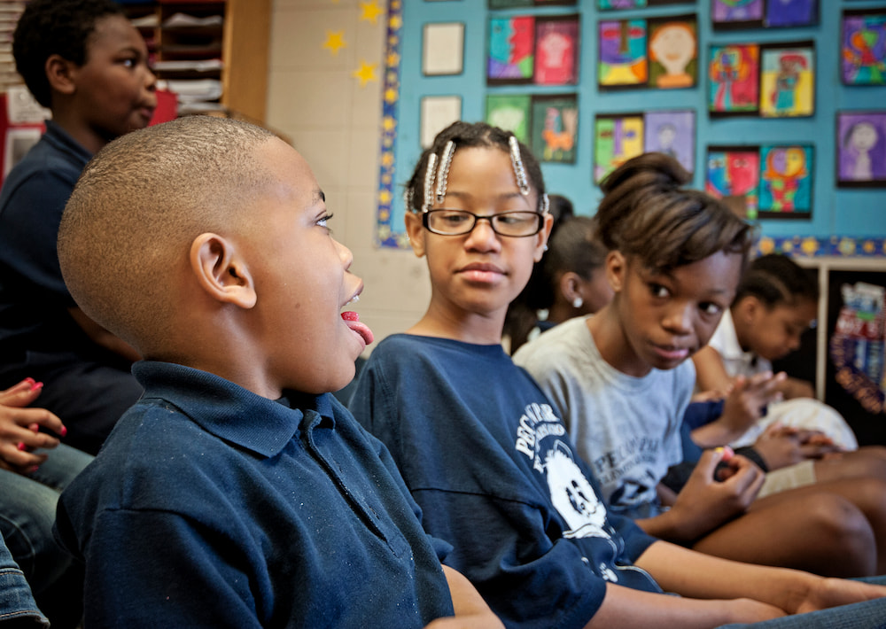 Nicolas McKee, left, entertains, from left, Kirstin Lakes and Charity Ashford with a view of his tongue and a Warheads sour candy during a lesson on the sense of taste.