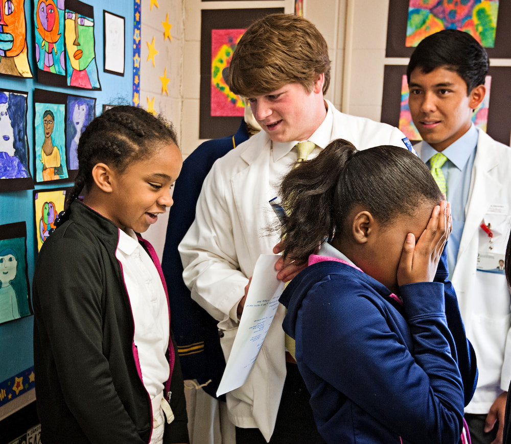 Phelicity Lett, far left, receives instructions from Turner Brown before she and Madisen Moses, right foreground, participate in a demonstration involving the sense of touch.