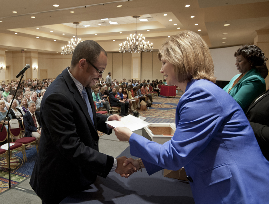 Dr. LouAnn Woodward, right, associate vice chancellor for health affairs and vice dean of the School of Medicine, gives Willie Thompson, Jr. his match envelope. He matched with East Tennessee State University in psychiatry.