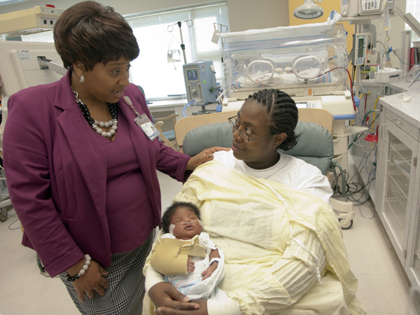 Whitaker gives comfort to Johnson-Robertson as she cradles her six-day-old son, Kaheim.