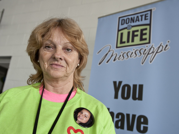 Belinda Smith proudly displays a photo of her daughter Kira Barrett, an organ donor.