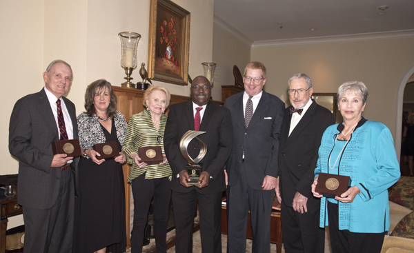 Medical Alumni & Friends Awards Dinner honorees or their family members are, from left: Dr. James Hughes; Dr. Barbara Goodman, who accepted the honor on behalf of Dr. Charles Castle; Jan Evers, who acknowledged the honor on behalf of her late husband, Dr. Carl Evers; Dr. Claude Brunson, recipient of the Distinguished Medical Alumnus Award; awards presenter Dr. Erik Richardson, president of the Medical Alumni Chapter; Dr. John Jackson; and Kathryn Boronow, who received the award on behalf of her late husband, Dr. Richard Boronow.