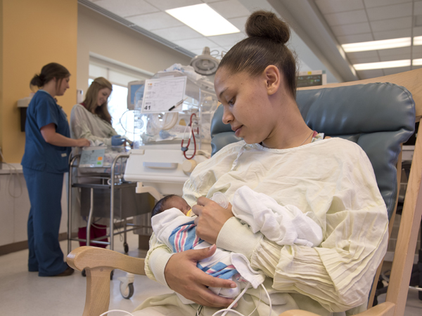 Jones feeds her new son, A'mari.