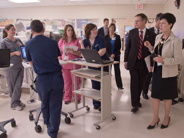 Savich (far right) and Vitter (second from right), chat with residents and fellows at the University of Mississippi Medical Center's NICU.