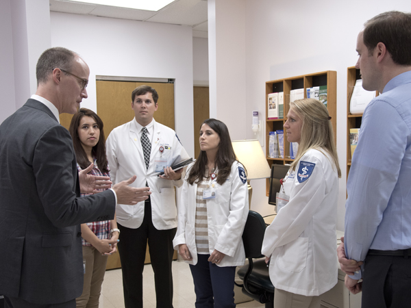 Rodgers, far left, and Tull, far right, discuss treatment of bipolar disorder with, from left, Dr. Sadia Haque, a fourth year psychiatry resident; and third-year medical students Jeremy Archer, Tara Lewis and Julie Waddle.
