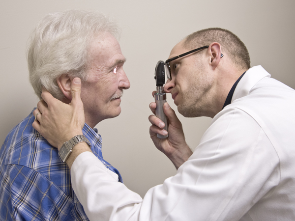 Ronnie Smith of Florence, left, goes in for a checkup with Dr. Zeb Henson.