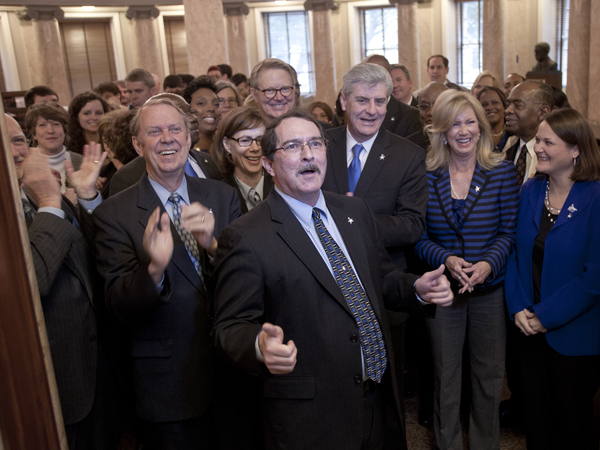 Dr. Roy Duhe, associate director for cancer education at the Cancer Institute at the University of Mississippi Medical Center, leads a cheer proclaiming a goal of 70 percent of Mississippians get screened for colorectal cancer by the year 2020.