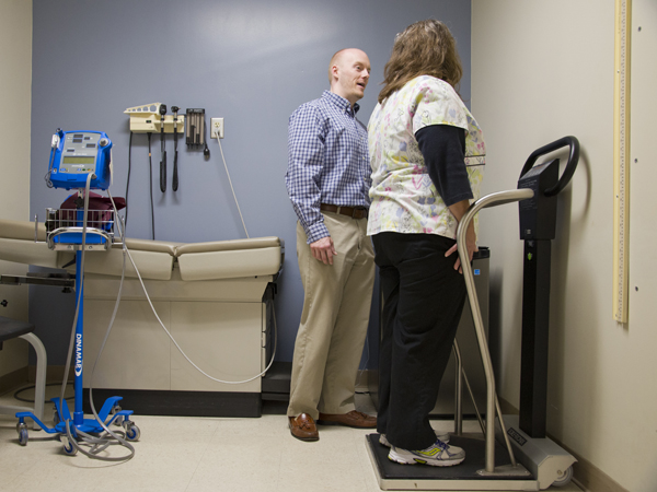UMMC registered dietitian Paul Robertson takes the weight and height measurements of patient Edna Taylor of Bentonia.