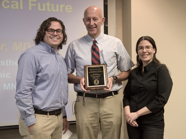 Joyner, center, receives an honorary plaque from PIT leaders John Henry Dasinger and Dr. Carolina Dalmasso.