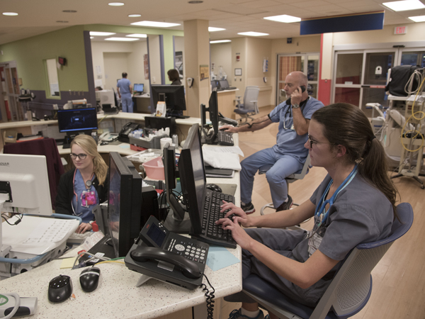 (From left) Registered nurses Carsyn Byars, Danny Smith and Kelly Green input information about patients being seen in the Pediatric Emergency Department.
