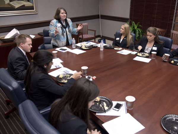 Dr. Mitzi Norris, executive director for academic effectiveness, explains the finer points of dining etiquette.