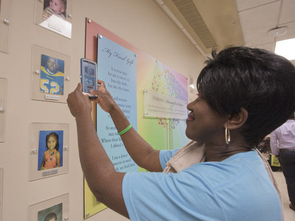 Jackie McInnis of Mount Olive takes a photo of her son Gary's display on the pediatric Wall of Heroes.