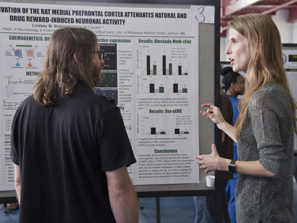 Bishop explains her research to Dr. Ryan Darling, associate professor of neurobiology and anatomical science.