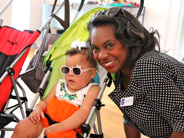 Kenleigh Fugate, one of identical quadruplets born at UMMC, and Charlotte Seals, president of the Junior League of Jackson, share a moment at the Rockin' Mamas Reunion.