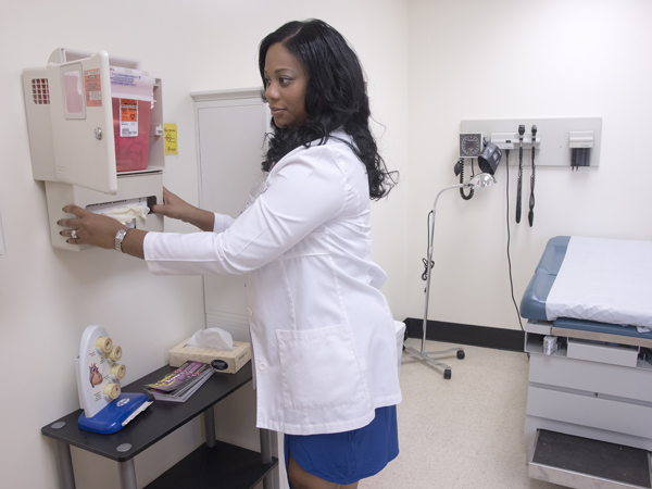 Lee puts finishing touches on installation of equipment at the new Lanier High School Teen Wellness Clinic.