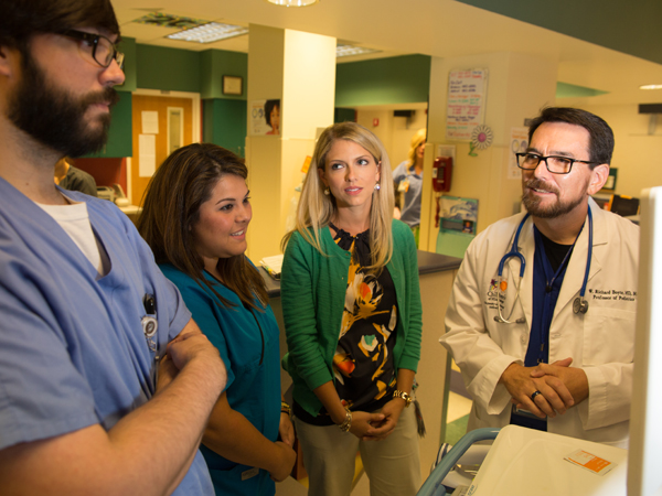 Boyte makes morning rounds at Batson Children's Hospital with his team, from left, Dr. Christian Paine, assistant professor of pediatrics, Regina QaDan, NP, and Dr. Jenna Dear, fellow in pediatric hospice and palliative care. Photo credit: The Schwartz Center for Compassionate Healthcare