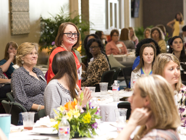 During the April 1 SHRP Alumni Day event, Dr. Shaz Edgerton, standing, assistant professor of radiological sciences, is recognized as one of the first graduates of SHRP's Doctor of Health Administration program.